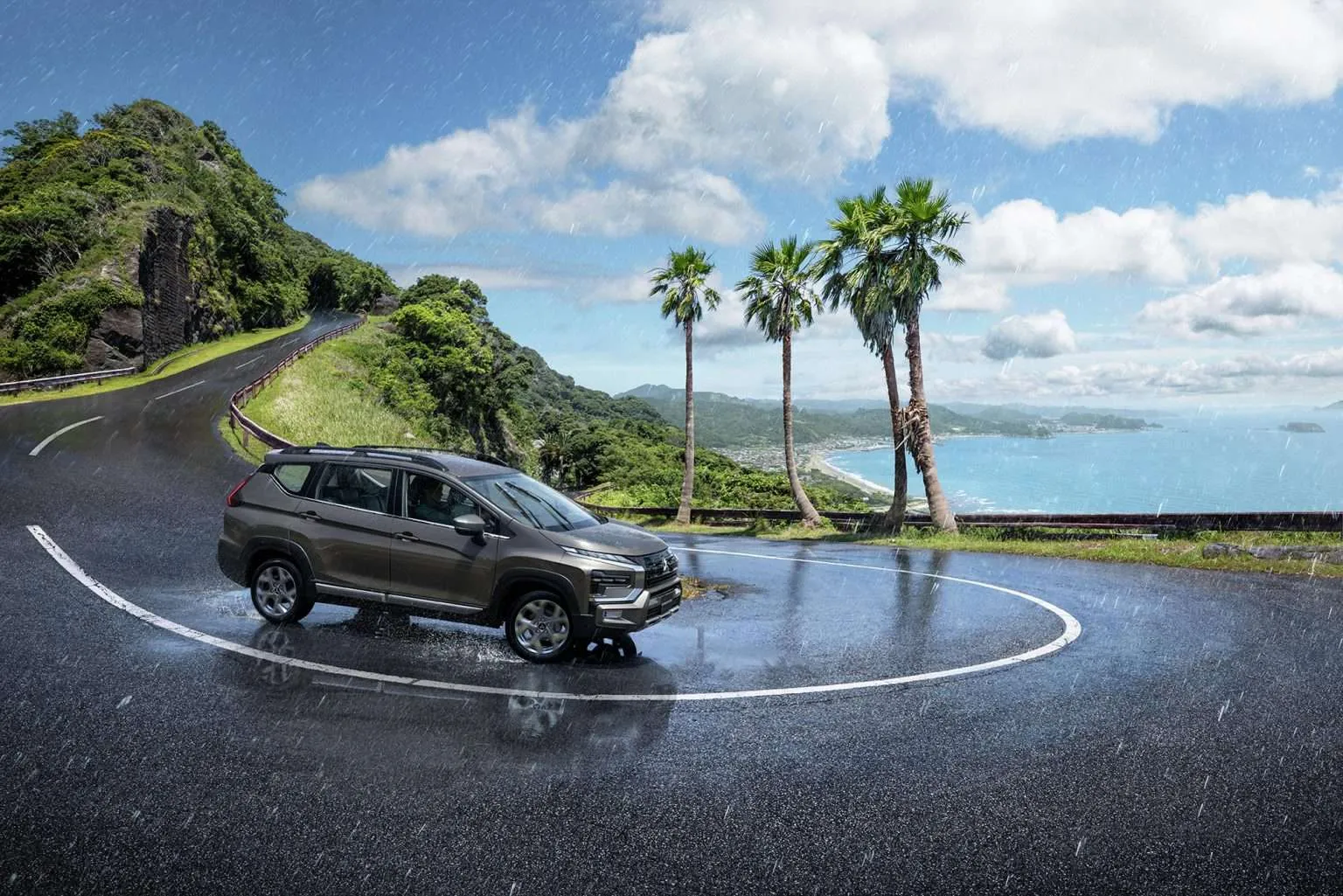 Mitsubishi Xpander Cross on a wet coastal hairpin road